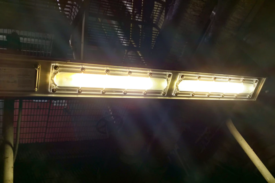 Linear Explosion Proof Light hanging from an industrial walkway