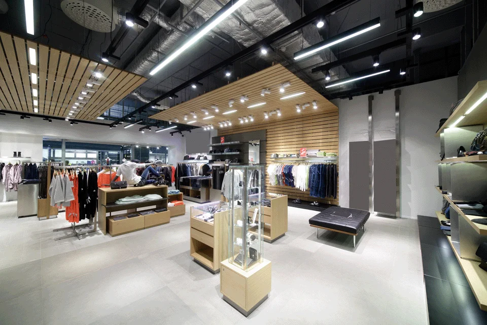Wide angle image of inside of a modern looking clothing store